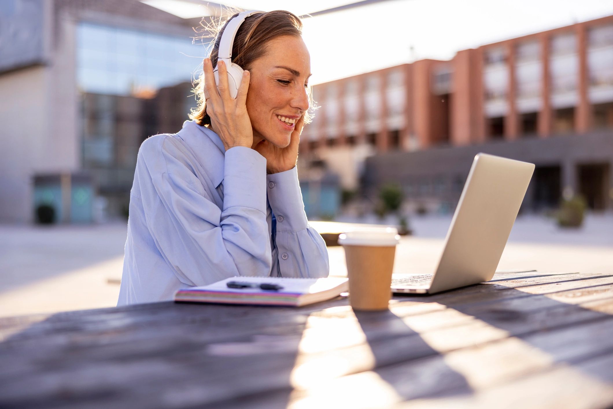Learner using a laptop in a bright modern setting